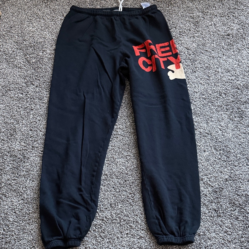 freecity navy blue sweatpants with red logo and cream accent